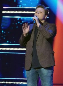 Carter Rubin singing on stage at The Voice