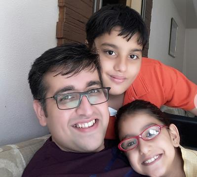 Madhav Sheth hugging his two children