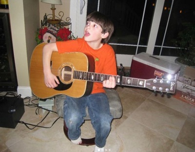 Troy Zarba childhood picture while posing with guitar