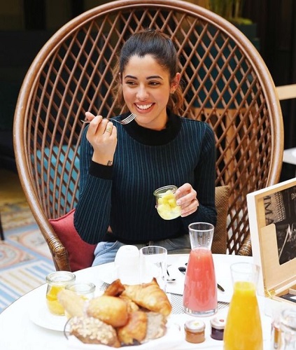 Coralie Porrovecchio enjoying breakfast in Paris, New York