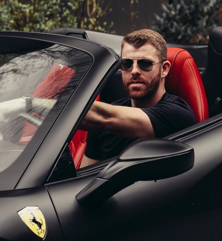 Damian Powers in his Ferrari