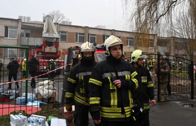 Firefighters working near the site where helicopter crash took place