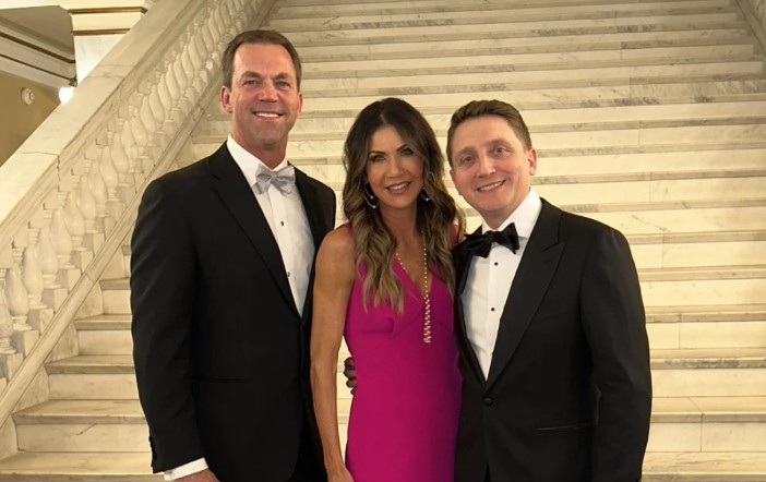 Benjamin Yoho (right) poses with Gov. Kristi Noem and Bryon Noem in the South Dakota Capitol