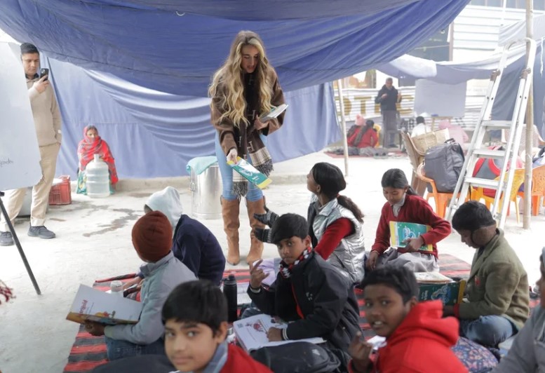 Sophie Shine distributes books to underprivileged children through the Shikhar Dhawan Foundation